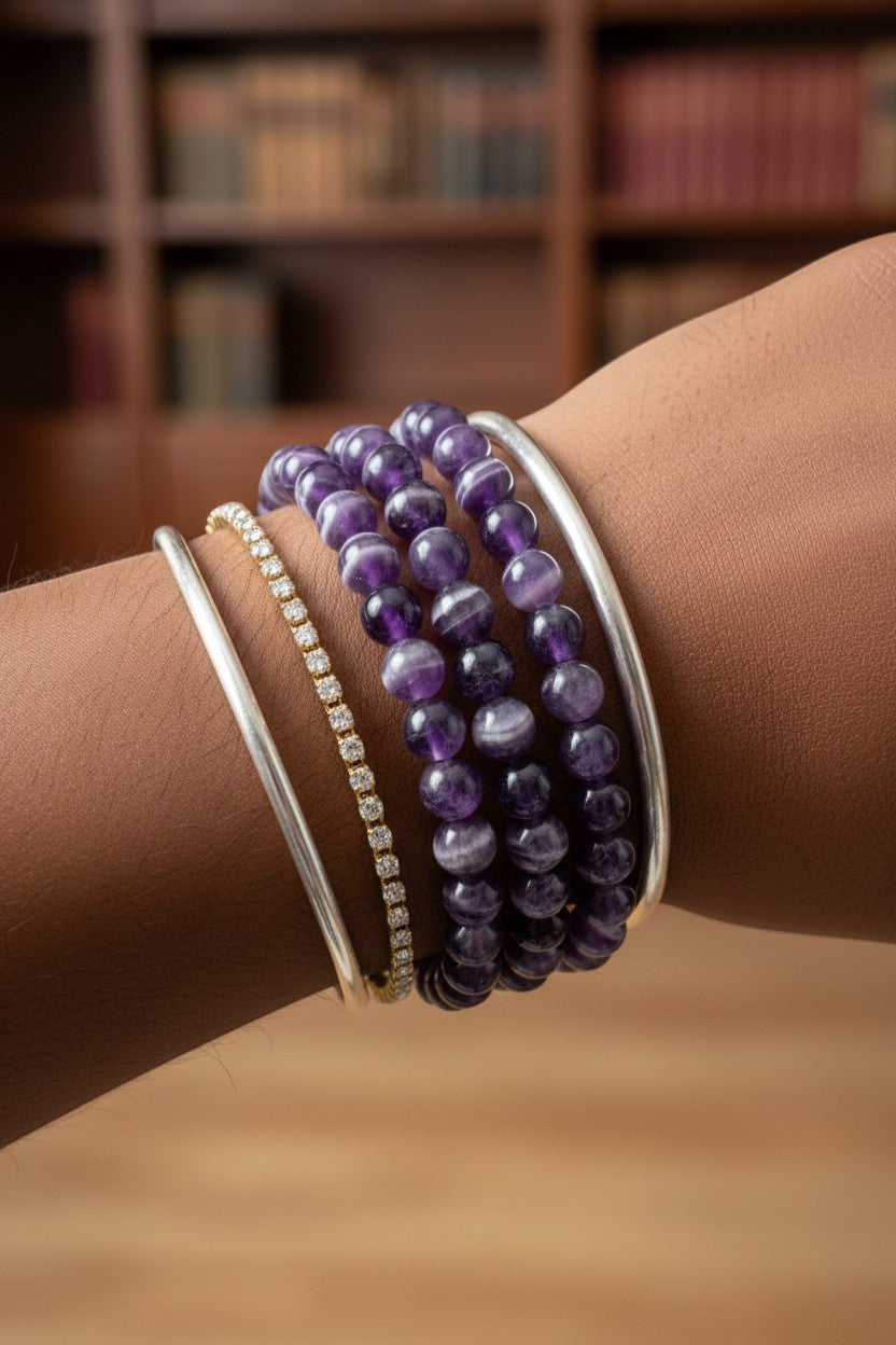 The Crystalary Dream Amethyst Chevron Amethyst crystal bracelet with purple and white bands on elastic.