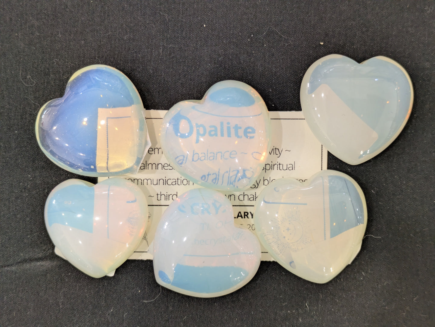 Opalite heart-shaped stones on a dark background