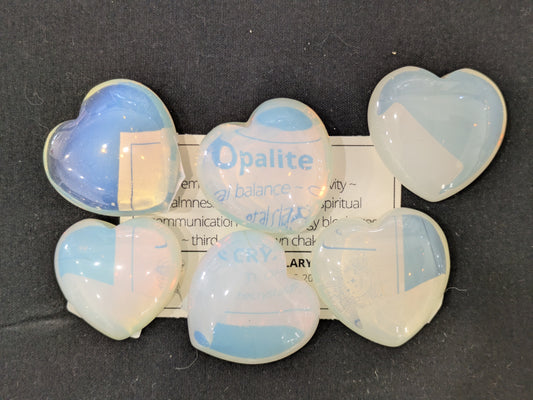Opalite heart-shaped stones on a dark background
