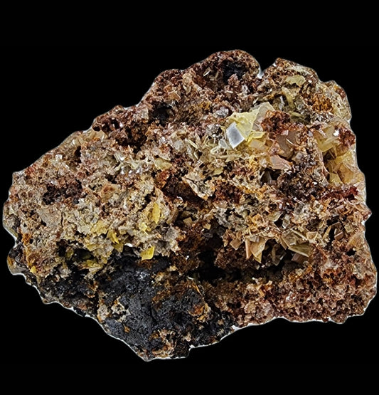 Close-up of a rough Wulfenite specimen from the Glove Mine, part of the Glive Mine Group in Cottonwood Canyon, Tyndall Mining District, Santa Cruz County, Arizona. Featuring a mix of earthy brown and yellow hues, this piece showcases prominent crystalline formations and a coarse texture with reflective, glass-like surfaces scattered throughout. The specimen from The Crystalary is isolated on a solid black background.