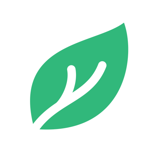 A green leaf icon, featuring a white twig-like vein pattern at its center, is set against a plain white background. The leaf's smooth and simplistic design symbolizes Shipped's Carbon Neutral Shipment efforts to neutralize carbon emissions and combat climate change.